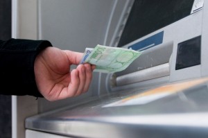epa01588989 A young man withdraws euro notes from a cash machine in Bratislava, Slovakia on 01 January 2009. Slovakia has become the 16th member of the eurozone, the second former communist country to join the grouping on 01 January 2008. The Slovak koruna (crown) will remain in circulation alongside the euro until 16 January.  EPA/PETER HUDEC