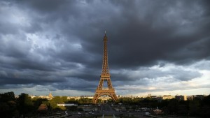 The Eiffel Tower is seen under clouds in Paris