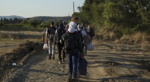 Refugees walk towards Gevgelija in Macedonia, after crossing the boarder from Greece, 23 August 2015. The Macedonian government organised buses and trains to provide transit to the Serbian border in the North of the country. According to the Macedonian NGO Legis, which provides aid to refugees at Gevgelija train station, many of those arriving from Syria show signs of injuries sustained as a result of the armed conflict.
