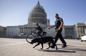 U.S. Capitol Police officers keep watch over the East Front of the Capitol as Congress prepares to return to work following the weekend terror attacks in Paris that killed 129 people, in Washington, Monday, Nov. 16, 2015. President Barack Obama conceded that the attacks were a setback in the fight against the Islamic State, but dismissed critics who have called for the U.S. to change or expand its military campaign against the extremists. (AP Photo/J. Scott Applewhite)