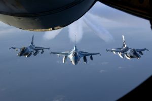 Three F-16 Fighter jets flies in formation on their way to a new home behind a KC-135 Stratotanker after their refueling on January 20, 2008. Eielson AFB and Kunsan Air Base swapped seven F-16 jets as a part of the Common Configuration Implementation Program (CCIP). (U.S. Air Force photo by: Staff Sgt. Eric T. Sheler)