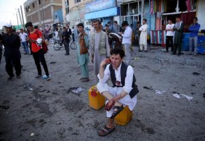 CAPTION CORRECTION: CORRECTS NAME OF PHOTOGRAPHER TO MASSOUD HOSSAINI -- A bloodied man who carried dead and wounded, speaks on the phone at the site of a suicide attack an explosion that struck a protest march, in Kabul, Afghanistan, Saturday, July 23, 2016. Witnesses in Kabul say that an explosion causing multiple casualties struck the march by members of Afghanistan’s largely Shiite Hazara ethnic minority group, who were demanding that a major regional electric power line be routed through their impoverished home province. (AP Photo/Massoud Hossaini)