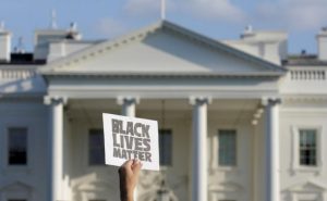 A demonstrator with Black Lives Matter holds up a sign during a protest in front of the White House in Washington, U.S., July 8, 2016. REUTERS/Joshua Roberts