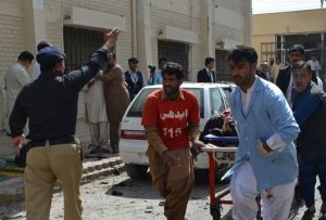 Pakistani volunteers rush an injured person for medical help following a bomb blast in Quetta, Pakistan, Monday, Aug. 8, 2016. A powerful bomb went off inside a government-run hospital in the southwestern city of Quetta on Monday, killing dozens of people and wounding dozens of others, police said. (AP Photo/Arshad Butt)