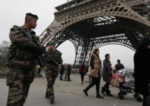French soldiers patrol near the Eiffel Tower in Paris as part of the highest level of "Vigipirate" security plan after a shooting at the Paris offices of Charlie Hebdo January 7, 2015. Gunmen stormed the Paris offices of the weekly satirical magazine Charlie Hebdo, renowned for lampooning radical Islam, killing at least 12 people, including two police officers in the worst militant attack on French soil in recent decades. The French President  headed to the scene of the attack and the government said it was raising France's security level to the highest notch. REUTERS/Gonzalo Fuentes  (FRANCE - Tags: CRIME LAW MILITARY)