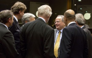 Greek Foreign Minister Nikos Kotzias, third right, speaks with, from left, Slovenian Foreign Minister Karl Erjavec, Dutch Foreign Minister Bert Koenders, Belgian Foreign Minister Didier Reynders, Finnish Foreign Minister Erkki Tuomioja and French Secretary of State for Foreign Affairs Harlem Desir during a meeting of EU foreign ministers at the EU Council building in Brussels on Thursday, Jan. 29, 2015. EU foreign ministers hold an extraordinary meeting on Thursday to discuss the latest fighting in Ukraine and possible further sanctions against Russia. (AP Photo/Virginia Mayo)