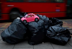 A toy model of a Volkswagen Beetle is seen on top of bags of rubbish ready for collection by waste collectors early in the morning outside a charity shop in London, United Kingdom, in this April 22, 2013 file photo.  REUTERS/Russell Boyce/Files