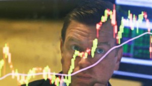 FILE - In this Aug. 25, 2015 file photo, specialist Michael O'Mara works on the floor of the New York Stock Exchange, in New York. As stocks swung wildly last month, average investors pulled a net $9.8 billion out of mutual funds targeting U.S. stocks and put $9 billion in the money market during the week ending Aug. 26, according to the Investment Company Institute, a trade group. The next week, the market rebounded and they reversed course, sticking $1.8 billion into U.S. funds.  (AP Photo/Richard Drew, File)