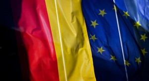 A German (L) and a European flag wave in front of a company in Dresden, Germany, 20 October 2011. Photo: Arno Burgi
