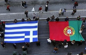Protesters carry flags of Portugal (R) and Greece as they march through Athens' Syntagma square during an anti-austerity rally November 14, 2012. REUTERS/Yannis Behrakis