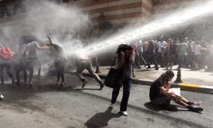 epa03724520 Turkish riot police use water cannons to disperse demonstrators during a protest against the planned construction of a new shopping mall at Taksim Square in Istanbul, Turkey, 31 May 2013. Protesting under the slogan 'OccupyGezi', activists have been staging a demonstration since 28 May to save Taksim Square. EPA/TOLGA BOZOGLU
