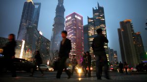 In a global survey, many respondents believe that China has overtaken or eventually will overtake the U.S. as the world's leading superpower. Chinese are shown here walking in Shanghai's financial district in March.