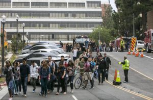 People are evacuated by Los Angeles Police officers from the UCLA campus near the scene of a fatal shooting at the University of California, Los Angeles, Wednesday, June 1, 2016, in Los Angeles. Los Angeles police chief says shooting at UCLA was murder-suicide. (AP Photo/Damian Dovarganes)