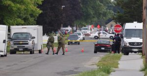 Police gather evidence outside of a house a day after a stand-off with authorities in Strathroy Ontario, Canada Thursday, Aug. 11, 2016. Suspect Aaron Driver was killed in a confrontation with police.   (Dave Chidley/The Canadian Press via AP)