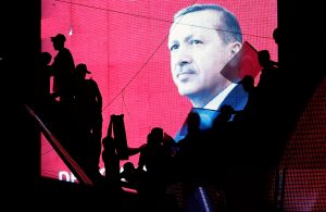 Turkish Supporters are silhouetted against a screan showing President Tayyip Erdogan during a pro-government demonstration in Ankara