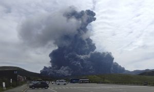 In this photo released by Aso Volcano Museum, a column of black smoke rises from Mount Aso on the southern Japanese island of Kyushu Monday, Sept. 14, 2015. The volcano has erupted, sending huge plumes of black and then white smoke 2,000 meters (6,560 feet) into the air. (Aso Volcano Museum via AP)